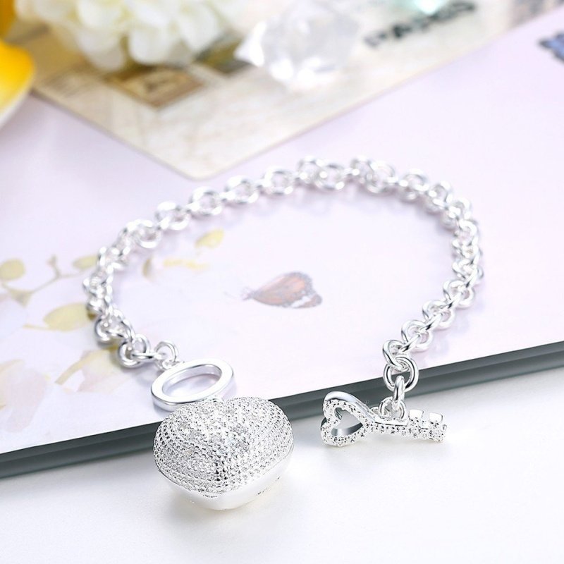 PULSERA ROLO CON CORAZON PLATA Y CIERRE LLAVE