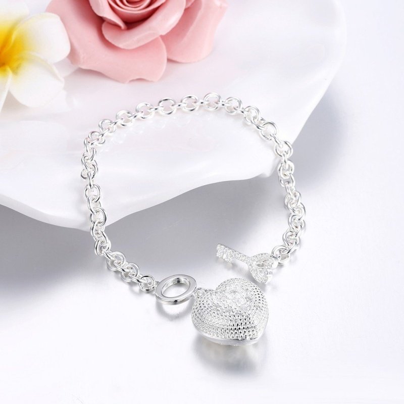 PULSERA ROLO CON CORAZON PLATA Y CIERRE LLAVE